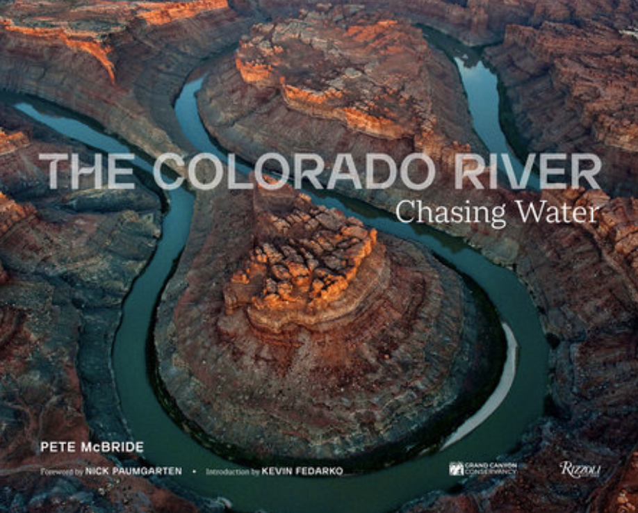 The Colorado River: Chasing Water cover; an aerial photo of a double oxbow of the Colorado River winding through the desert landscape near Canyonlands National Park.